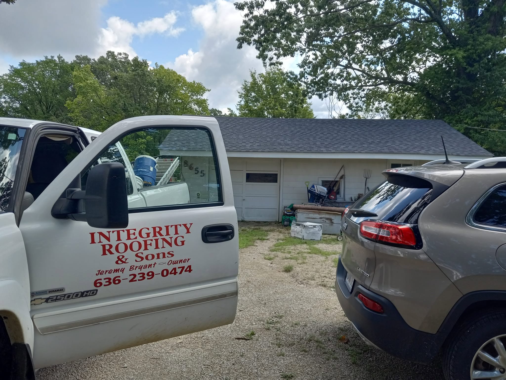Integrity Roofing & Sons work truck at a job site in Missouri